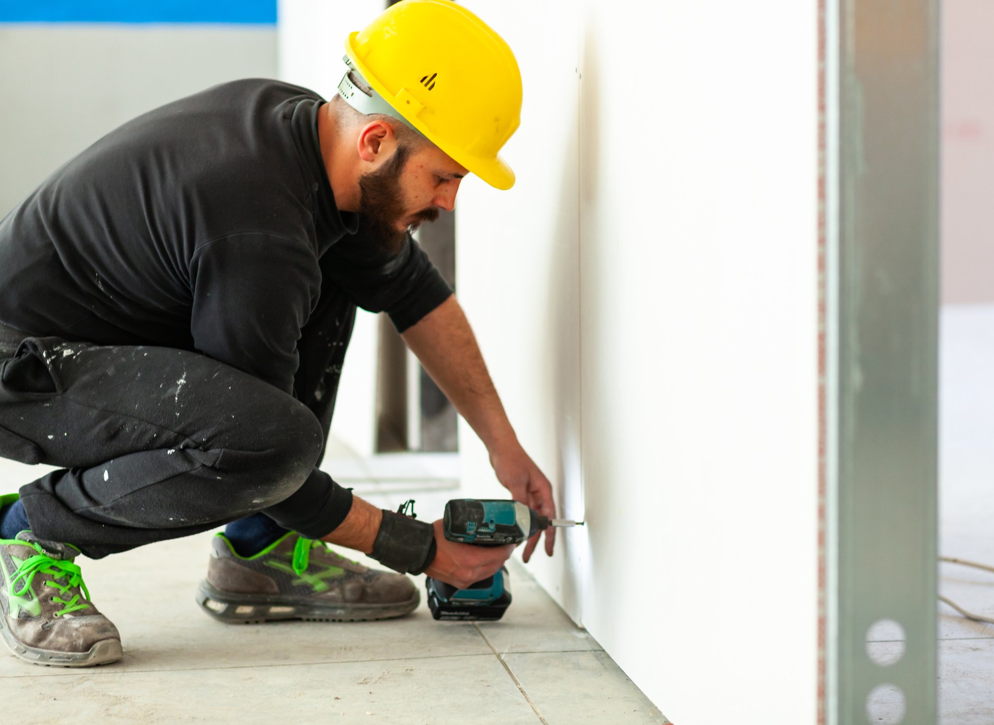 Worker Building a Plasterboard Wall